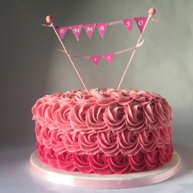 Ombre Rose cake with three tiers and raspberry icing